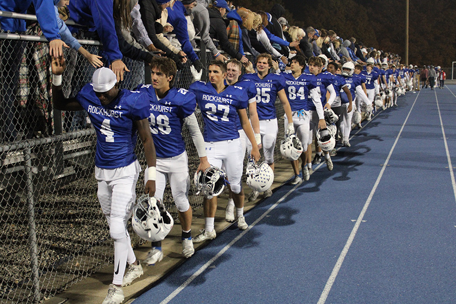 The Rockhurst football team high-fives fans after a crushing 49-42 loss to Park Hill on Oct. 28 in the first round of the playoffs. It was an emotional ending for seniors who donned their Hawklet uniform for the final time.