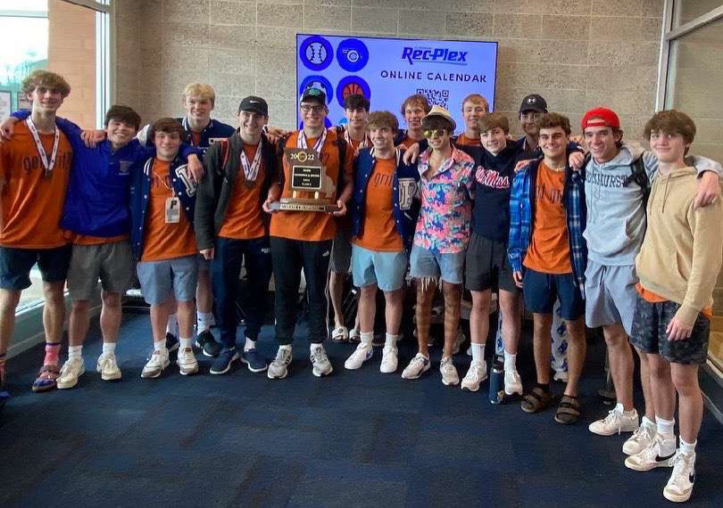 The 16 senior members of the Aquahawks pose with the state championship trophy Nov. 11, 2022. This year's senior class graduates having helped the team win three straight state titles.