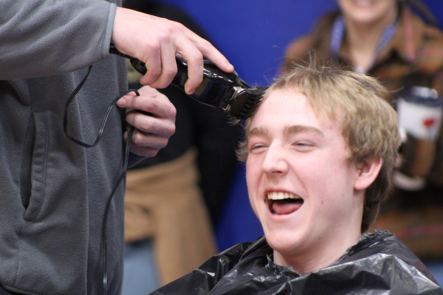 Senior Tate Slaymaker laughs as classmate Hayden Spachman cuts his hair during the Mission Week Board Game on Feb. 10, 2023. The cut turned out a bit uneven, but seniors still won the competition en route to winning the Board Game overall.
