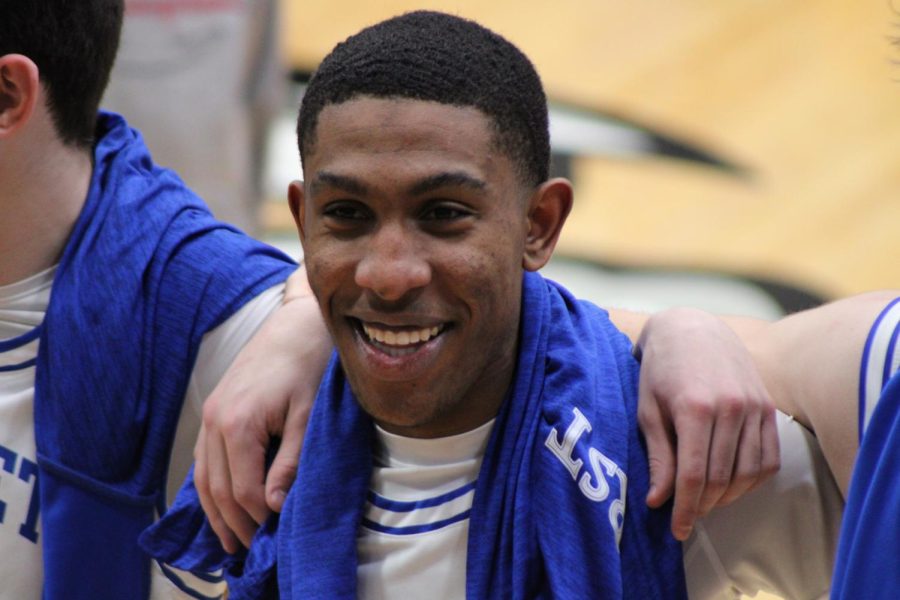 Senior Brian Humphrey smiles at the student section while everyone sings the Rockhurst alma mater following the Hawklets' 62-31 win over Lincoln Prep on Feb. 17, 2023. It was the last home game of Humphrey's Rockhurst career.