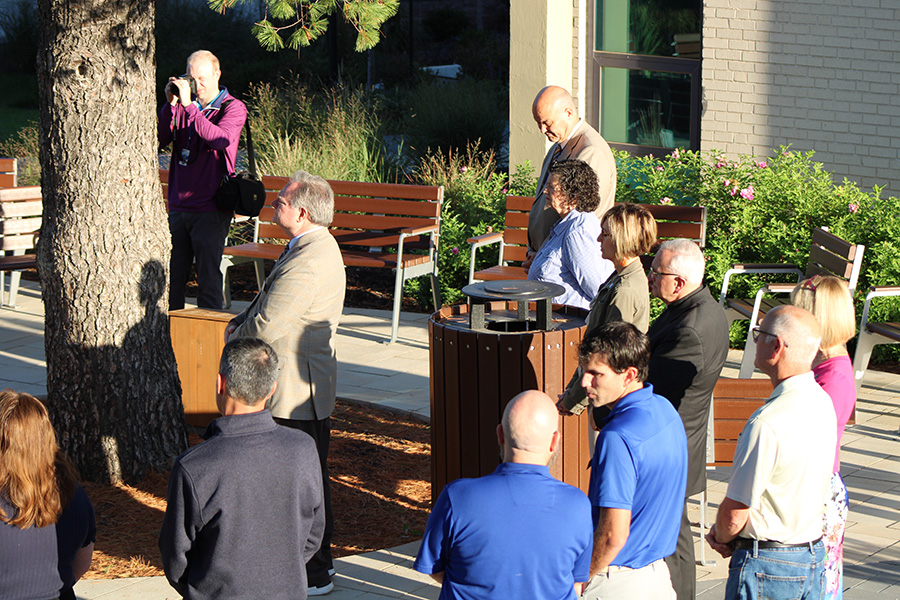 Faculty and staff listen to Principal Father Vincent Giacabazi address those gathered for the dedication of the Jack Nestor 34 Outdoor Classroom & Lab on Sept. 25, 2023.
