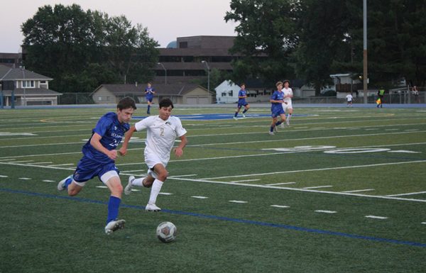 Senior defender Henry Mullen pushes past the Lees Summit defense. The Hawklets overcame a scoreless first half to net four goals in the second en route to their shutout win over the Tigers on Sept. 14, 2023.