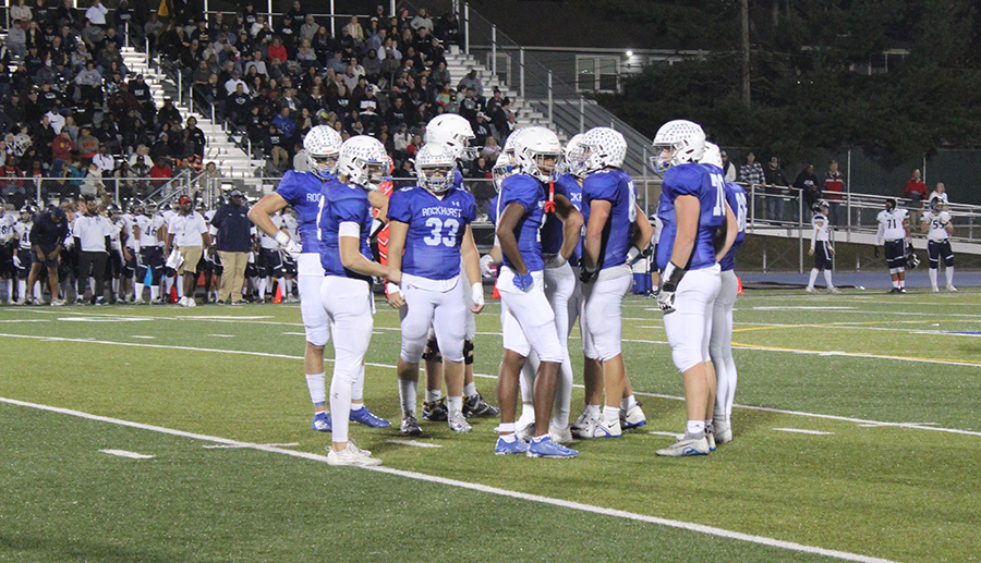 Senior quarterback Ethan Hansen and the rest of the offense await the play call during their district game against Lees Summit West on Nov. 3, 2023.