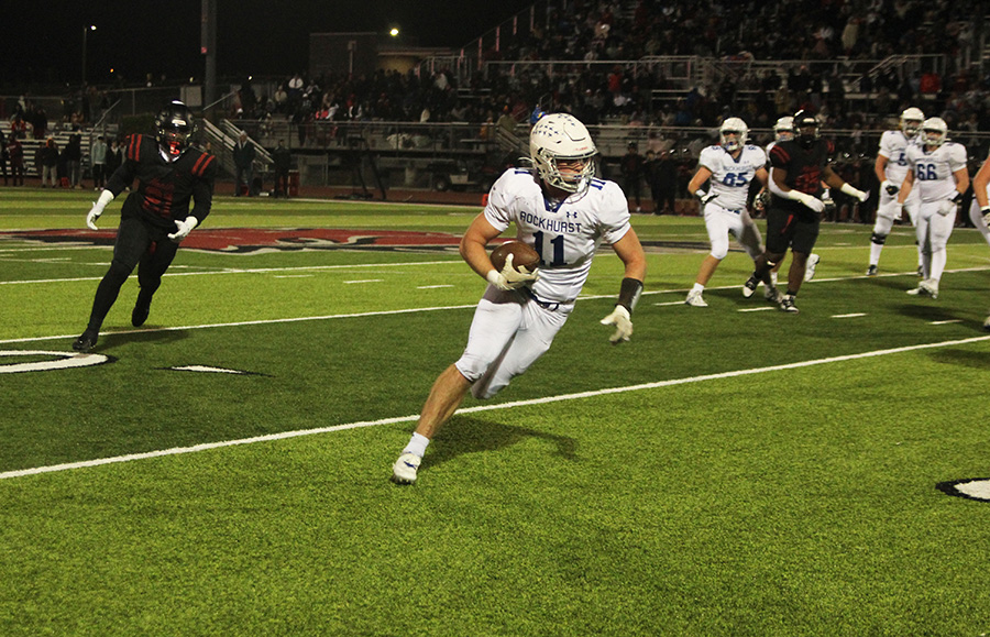 Senior tight end Mitch Forbes looking for running room after catching the pass in the flat during the district championship game against Lees Summit North on Nov. 10, 2023. Rockhurst beat the No. 1 team in the state 24-21 for their first district championship since 2018.