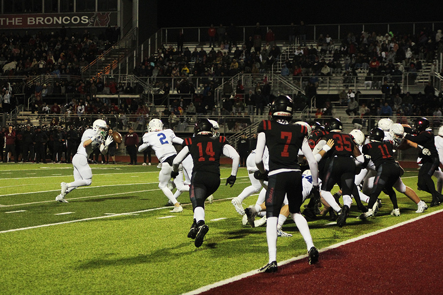 Senior running back Aidan Ryan grabs the pitch from senior quarterback Ethan Hansen late in Rockhursts district championship game against Lees Summit North on Nov. 10, 2023. Ryan, Hansen and the Hawklets offense would do enough to squeak by the No. 1 team in Missouri, 24-21, to give Rockhurst their first district title since 2018.