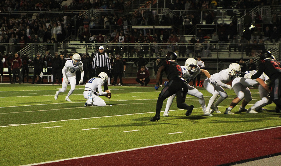 Senior kicker/safety Logan Kuechler approaches the ball during the district championship game against Lees Summit North on Nov. 10, 2023. It was a Kuechler kick that was the difference in Rockhursts 24-21 win.