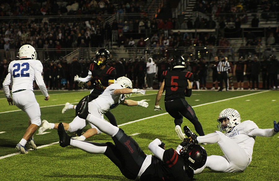 Junior linebacker Jeb Koetting dives after Lees Summit Norths Tanner Howes during the district championship game on Nov. 10, 2023. Koetting and the Hawklets pulled out the victory over the Broncos, 24-21, to win their first district title since 2018.