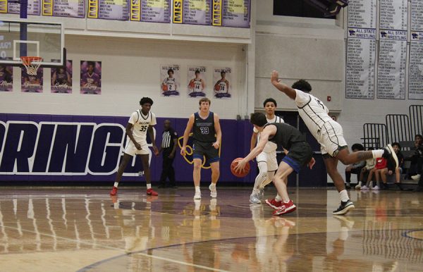 Senior guard Luke Johnson cuts in front of a Staley player during their Blue Springs School District Tournament game on Dec. 9, 2023. Rockhurst came back from a double-digit deficit in the 3rd quarter to tie the game, but fell short 49-41.
