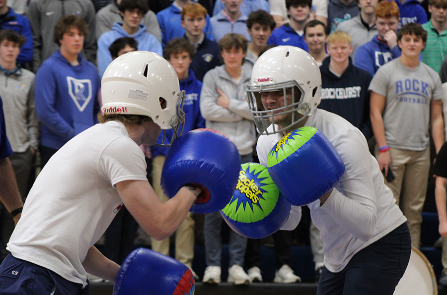 Freshman Matthew Monroe (right) waits for an opening to strike in his boxing match against sophomore Gentry Curtis during the pep rally on Jan. 26, 2024. Curtis would win the three-round match and advance to fight the junior class representative. The boxing was one of the games played during the pep assembly ahead of the rivalry basketball game against Shawnee Mission East.