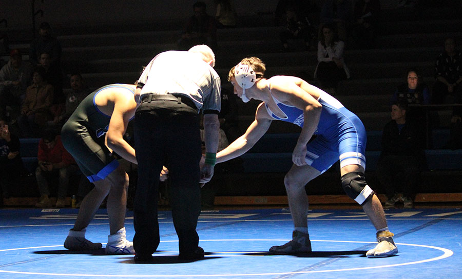 Rockhurst senior Robert Purcell (right) shakes hands with his opponent from Raytown ahead of their match on Dec. 6, 2023.
