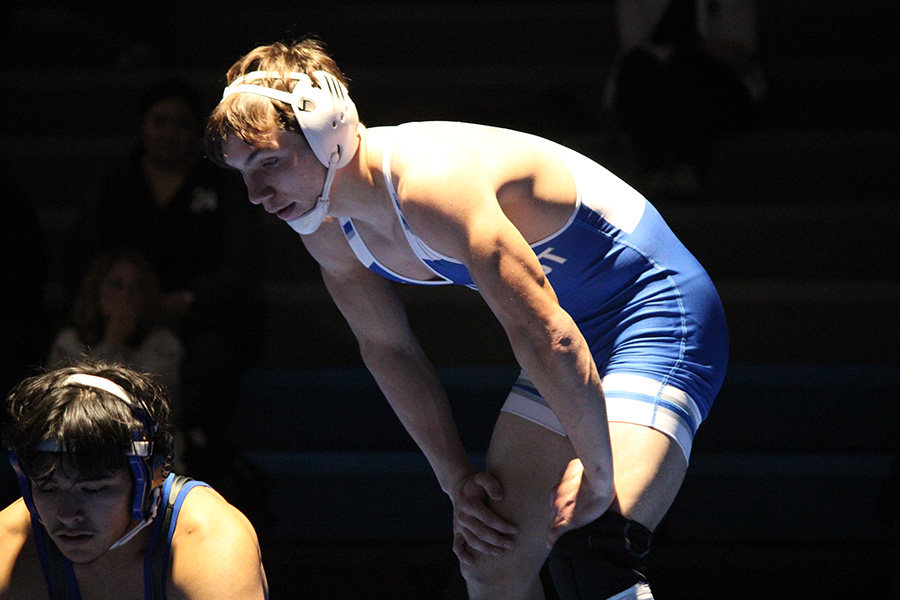 Rockhurst senior Robert Purcell prepares to take top position during his match against an opponent from Raytown on Dec. 6, 2023.