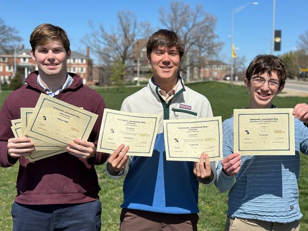 Mitch Forbes, Eli Rourke and Timmy Ottomanelli pose with some of the awards they and the entire Prep News staff received at Journalism Day on March 27, 2024.