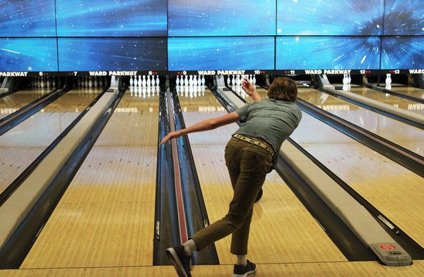 A student follows through during a game of bowling at Ward Parkway Lanes on Oct. 31, 2022.