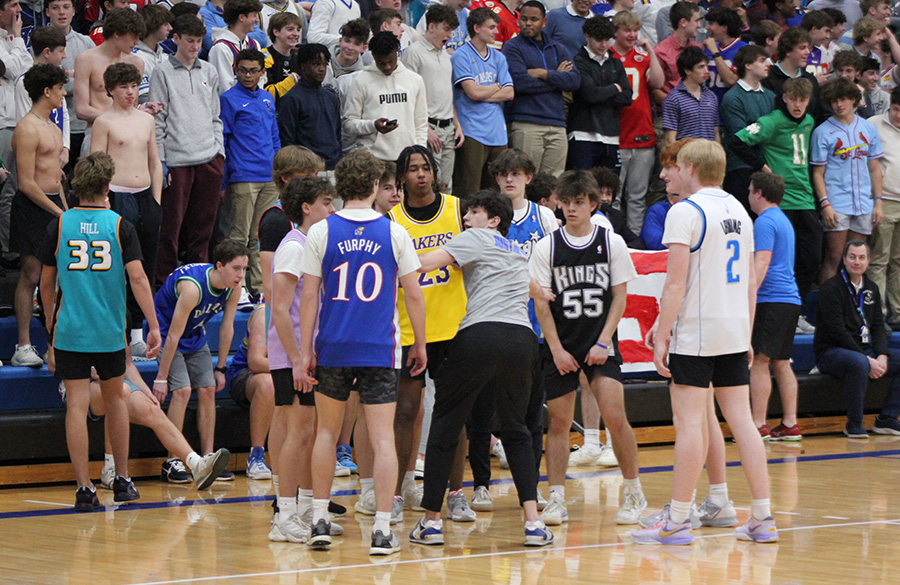 Senior Brady Maher (gray shirt) gives directions to the student team during the Faculty/Student Basketball Game on Feb. 27, 2024. Maher was one of members of the basketball team who led the student team. For the first time in a long time, the students emerged victorious in the contest, 39-34.