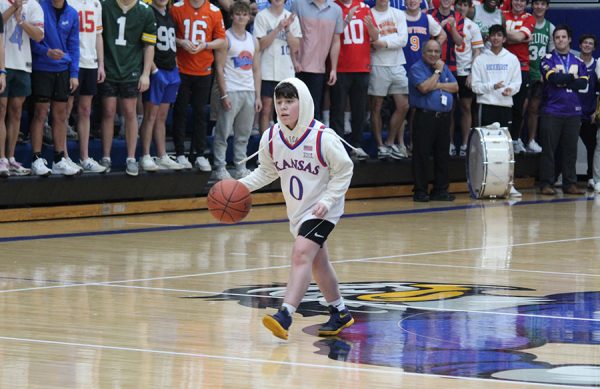 Sophomore Gray King brings the ball up court for the students during the Faculty/Student Basketball Game on Feb. 27, 2024. Gray hit a couple of big shots for the students, helping them beat the faculty for the first time in a long time.