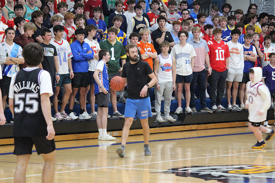 Theology teacher Jon Feder brings the ball up the court during the Faculty/Student Basketball Game on Feb. 27, 2024. For the first time in a long time, the faculty were unable to emerge victorious in the contest, falling 39-34.