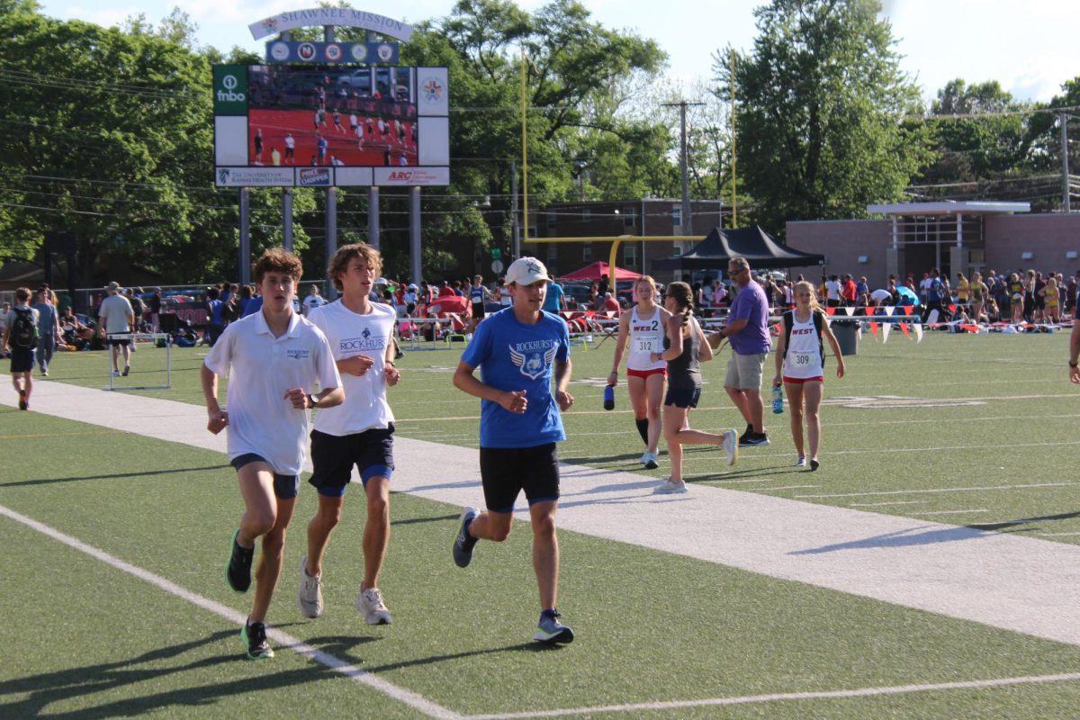 Juniors Henry Acorn, Andrew Davis and Bill Hayes warm up before their events at the Shawnee Mission North Relays on May 3, 2024.