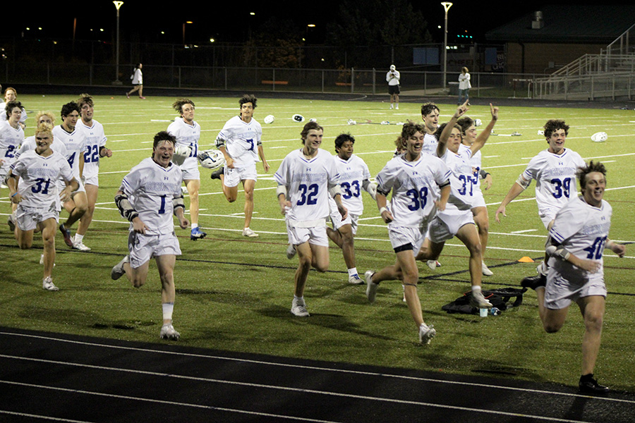 The team sprints across the field to celebrate with the Rockhurst student section following the Hawklets win in the LAKC championship on May 24, 2024. It was the fourth straight league title for Rockhurst.