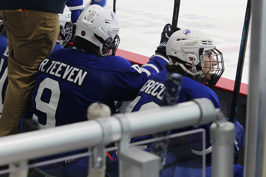 Junior Riley Teeven and senior Jonathan Greco wait for their numbers to be called to return to the ice during their game against Wichita on Nov. 24, 2024. Rockhurst lost both weekend games, and remain winless on the season.