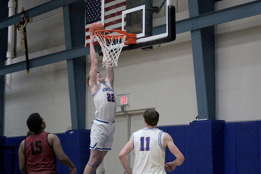 Junior Kevin Sullivan elevates for the dunk during the second half of Rockhurst's big win over Lee's Summit North on Dec. 16, 2024. Sullivan contributed 10 points as the Hawklets won by 25.