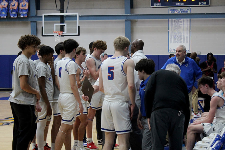 Coach Billy Thomas talks with his team during a timeout in Rockhurst's game against Lee's Summit North on Dec. 16, 2025. The Hawklets beat the Broncos 73-48 to move to 6-1 on the season.