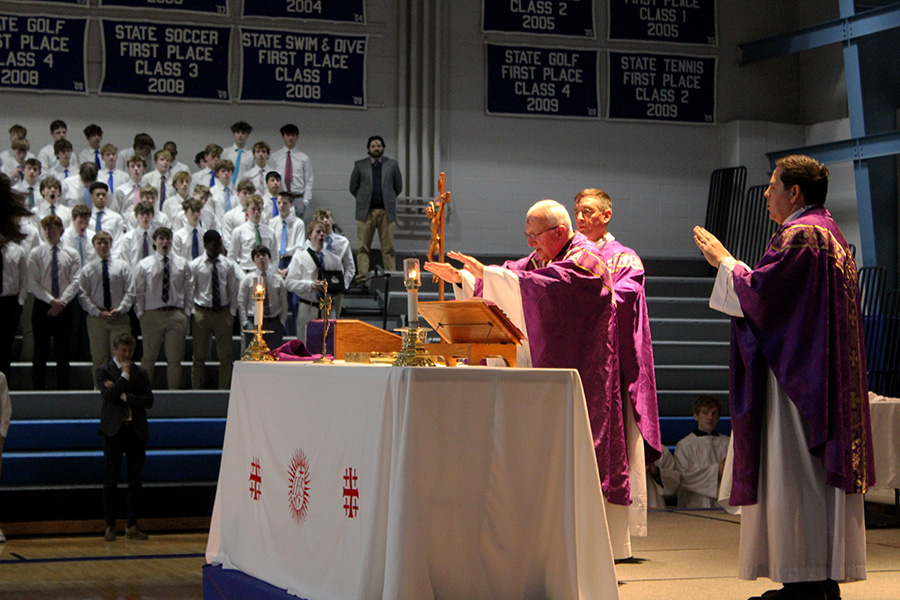 Rev. Tom Pesci, SJ, prays over the Host during Rockhurst's Ash Wednesday mass on Wednesday, March 5, 2025. The all-school service marked the beginning  of Lenten season.