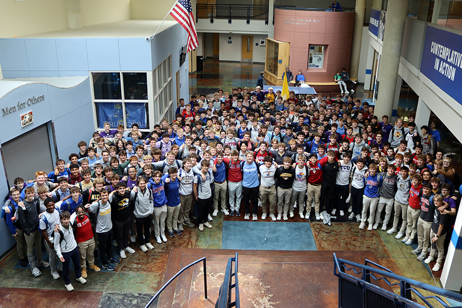 Every year seniors take a group picture wearing shirts bearing the college of their choice.