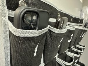 Phones hang in a phone 'tree' in a Rockhurst classroom. Each room in the school has one of these phone holders in which students are expected to leave their phones at the beginning of every class.