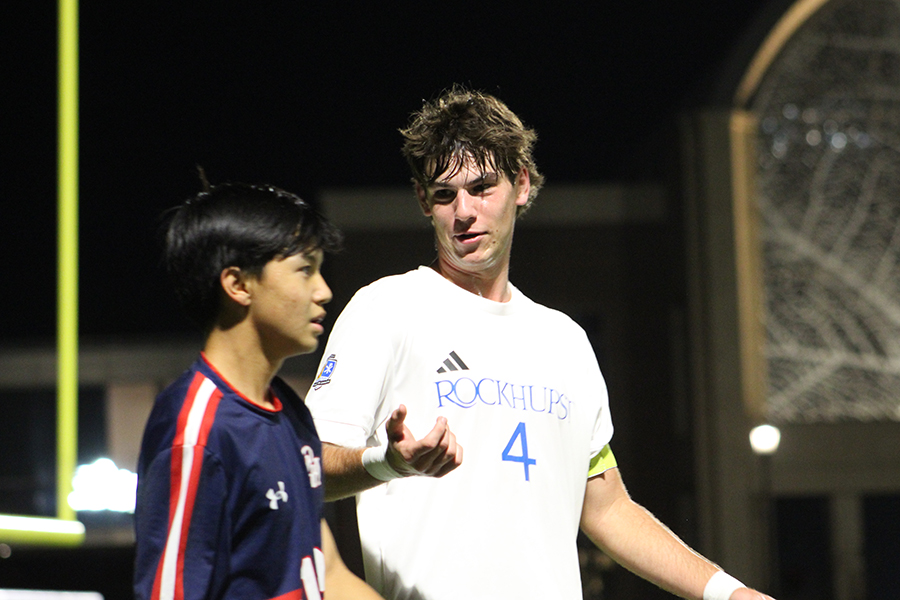 Senior Calvin Schieffer talks with a Pembroke Hill defender during their match on Oct. 7, 2025. The Hawklets controlled the match and beat the Raiders 4-0.