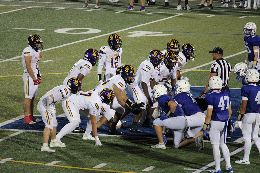 Blue Springs' quarterback Wyatt Erickson (kneeling in front of 12) takes a knee to run out the clock on the Wildcats' 38-29 win over Rockhurst on Oct. 3, 2025.