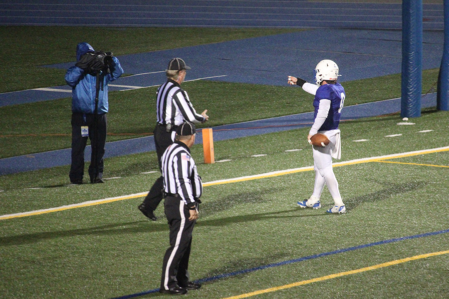Junior running back Cash Lewandowski points at a camera after scoring the last of his three touchdowns in the game against St. Louis University High on Oct. 24, 2025. Lewandowski single-handedly outscored SLUH, who could only muster 14 points, while the Hawklets put up 35.