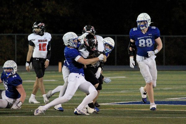 Senior safety Pierce Fisher stops the momentum of the Fort Osage ball carrier and tries to wrestle him to the ground during the district semifinal game on Nov. 7, 2025. The Hawklets defense kept the Indians out of the end zone until garbage time in the fourth quarter as they rolled to a 41-13 victory.