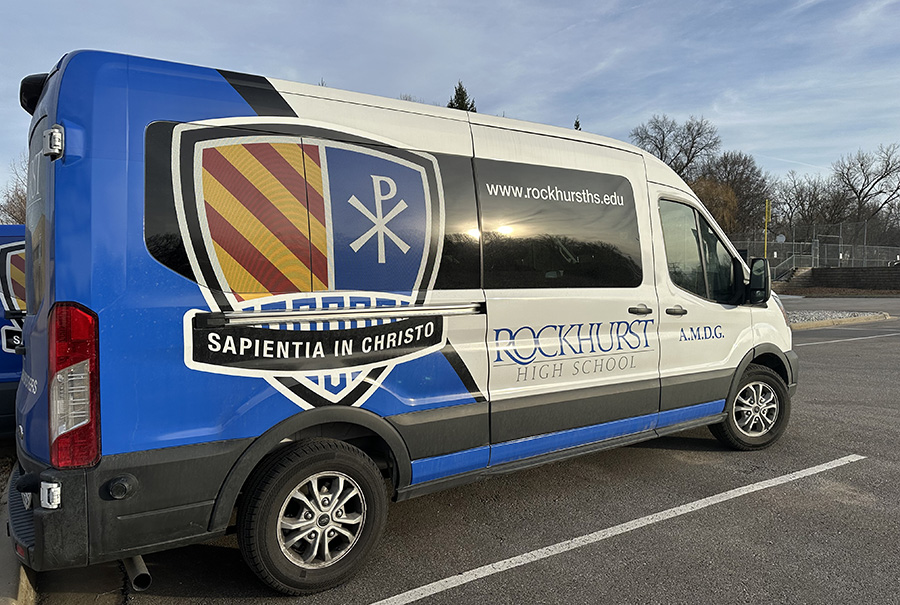Students who are utilizing the new shuttle service are picked up in vans emblazoned with Rockhurst imaging.