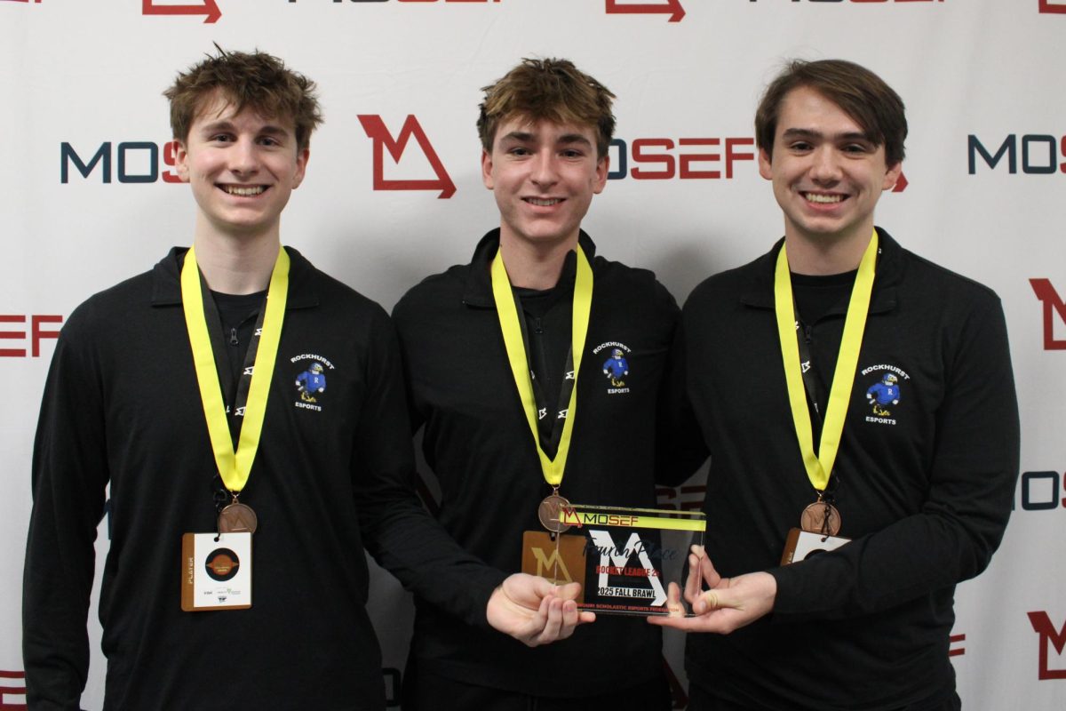 Junior Drew Shepherd, junior Vinny Gronberg and senior Xavier Aleman pose with their fourth-place trophy on Dec. 5, 2025. It was the first year Rockhurst competed in Missouri Scholastic Esports Federation (MOSEF).