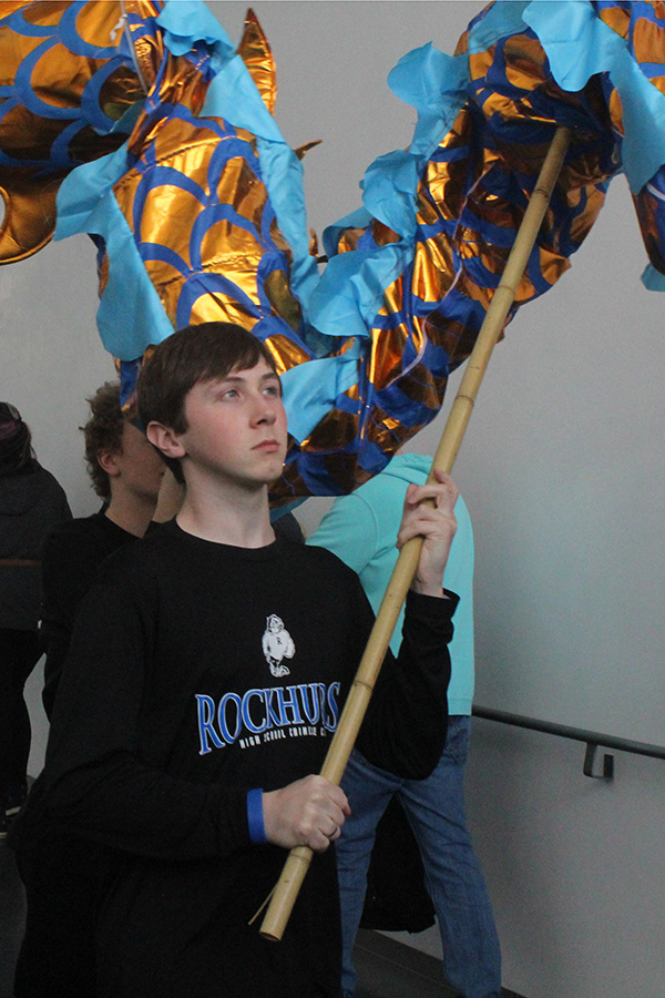 ________________ moves forward with the rest of the Rockhurst Dragon Squad as they prepared to perform during the Nelson-Atkins Museum of Art Lunar New Year celebration on Jan. 26, 2025.