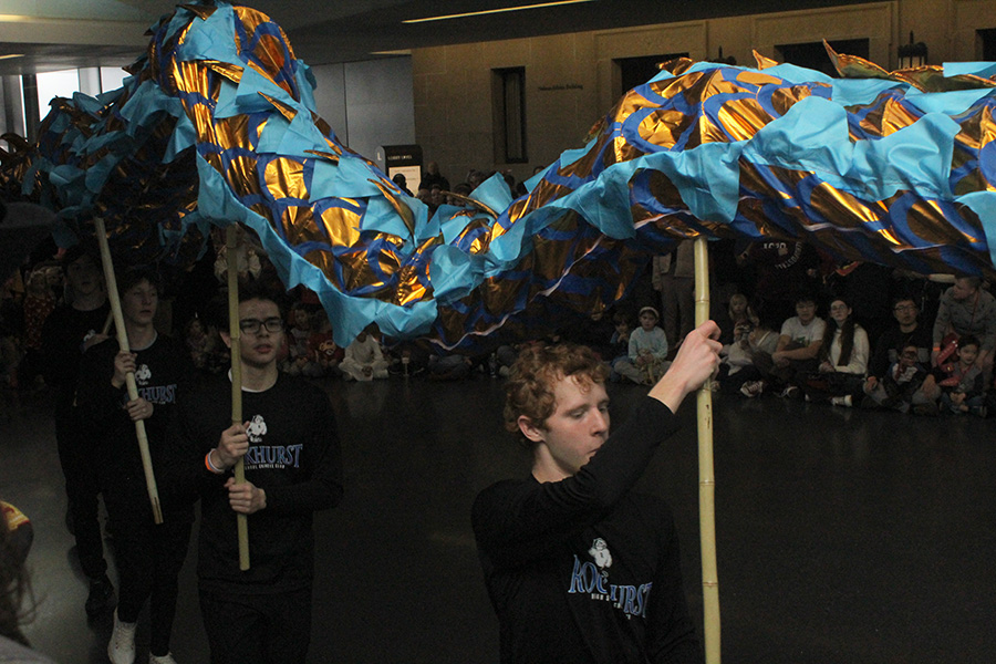 Senior Sam Reintjes (front) and sophomore John Kierspel perform with the Rockhurst Lion Dragon Squad during the Nelson-Atkins Museum of Art Lunar New Year celebration on Jan. 26, 2025.