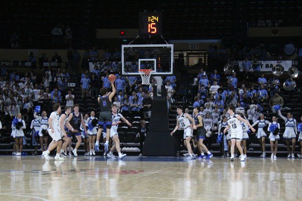 Senior Hueston Saunders puts up the floater in the first half of the rivalry game against Shawnee Mission East on Jan. 30, 2026. The basket would provide two of Saunders' 14 points in the Hawklets' 56-51 win, their fourth straight in the series. This was the first year the game was played at Municipal Arena in downtown Kansas City as opposed to on the campus of one of the schools.