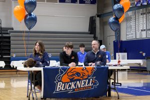 Senior Josh Battison and his parents listen to a speaker during the Signing Day ceremony on Feb. 4, 2026. Battison signed to swim at Bucknell University.