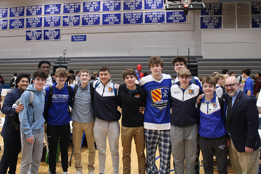 Members of the Rockhurst swim and dive team pose with senior Josh Battison (center, black quarter-zip) after the Signing Day ceremony on Feb. 4, 2026. Battison signed with Bucknell University.